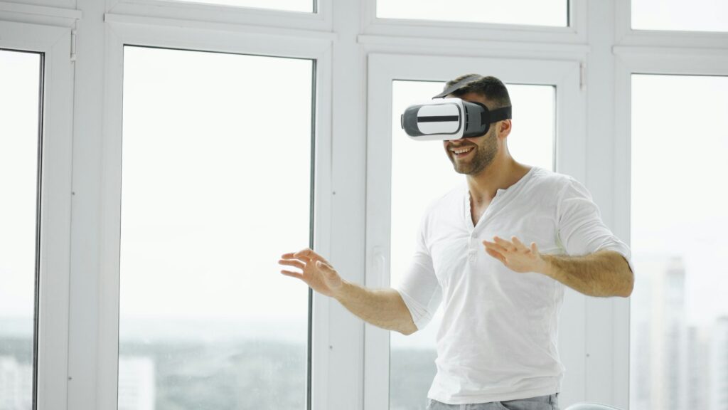 Man wearing a VR headset in a bright room, illustrating spatial computing and brand experience